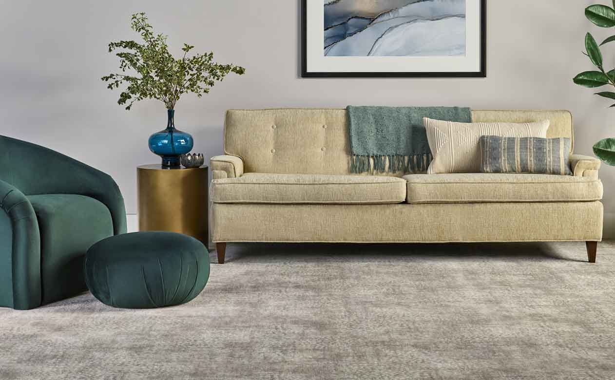 Greige plush carpet with tan sofa living room. 